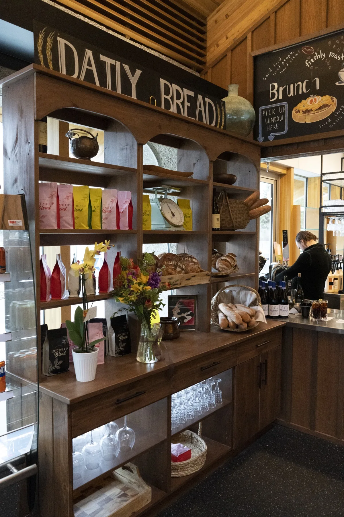 Daily Bread shelf with house-roasted Lift Me Up coffee blends and fresh baguettes